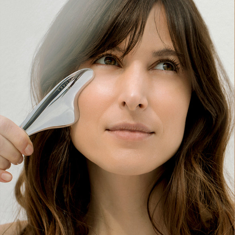 An image of a womans face using a Hadaka Soleil Microcurrent Gua Sha